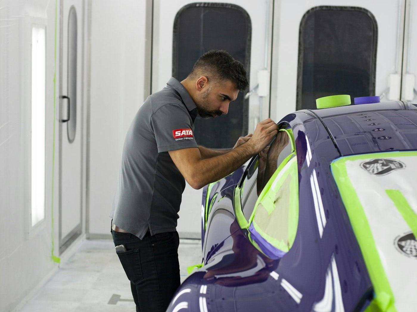 A car masked up in the paint booth before spraying